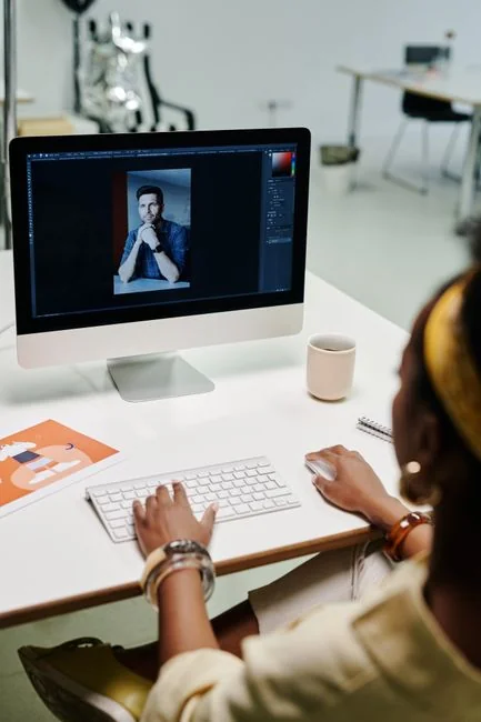 A team of designers working together in a contemporary office setting with a computer.